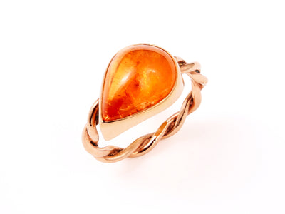 Pear-Shaped Spessartite Garnet offset in a 14kt Rose Gold Twist Band